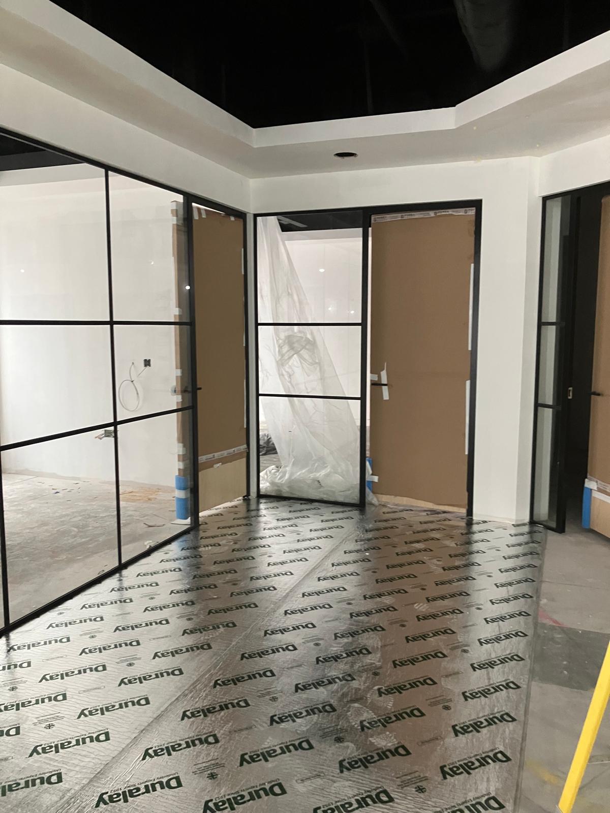 Crittall-style glass partition doors with floor protection